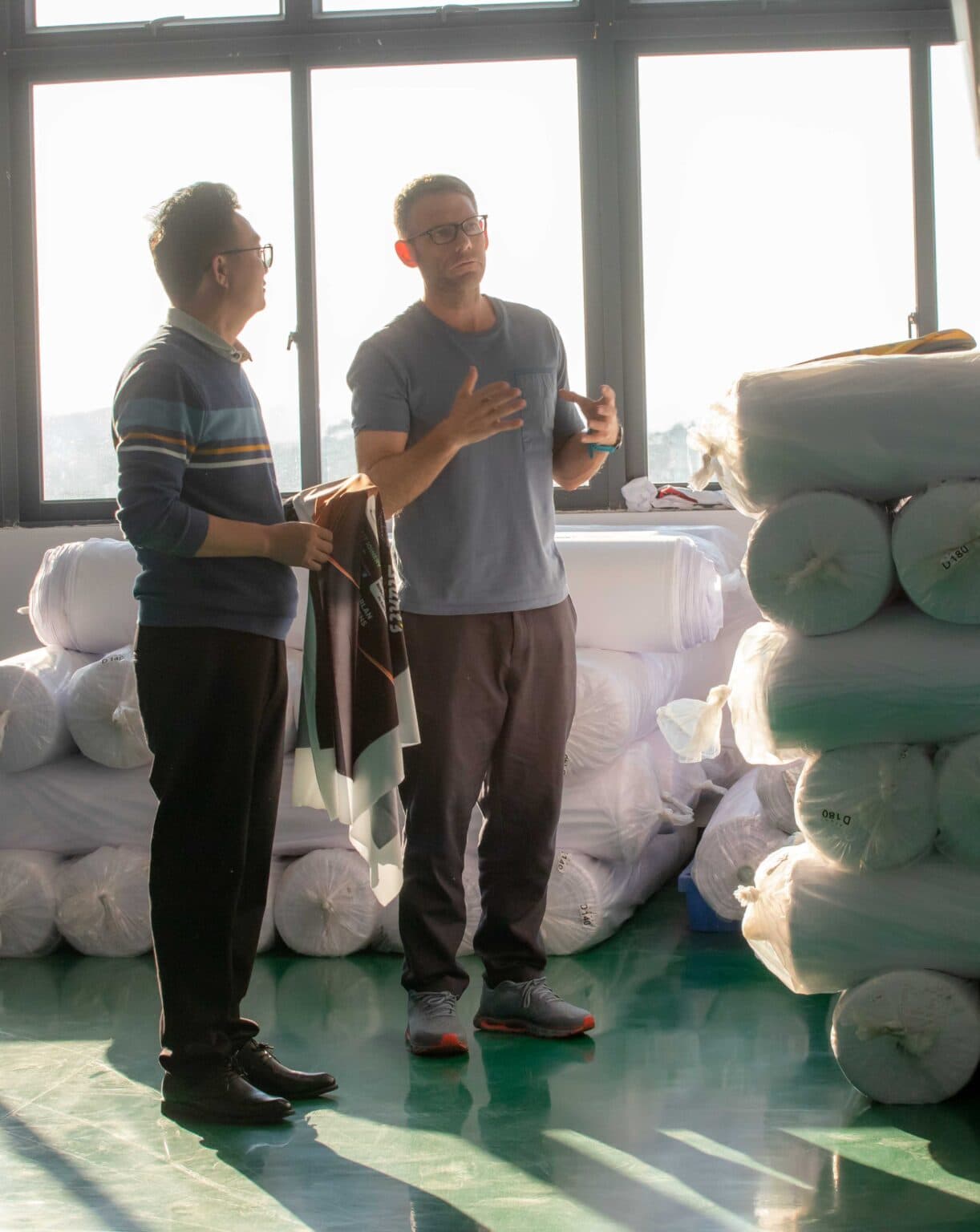 Sam Clay talking with factory partners in China