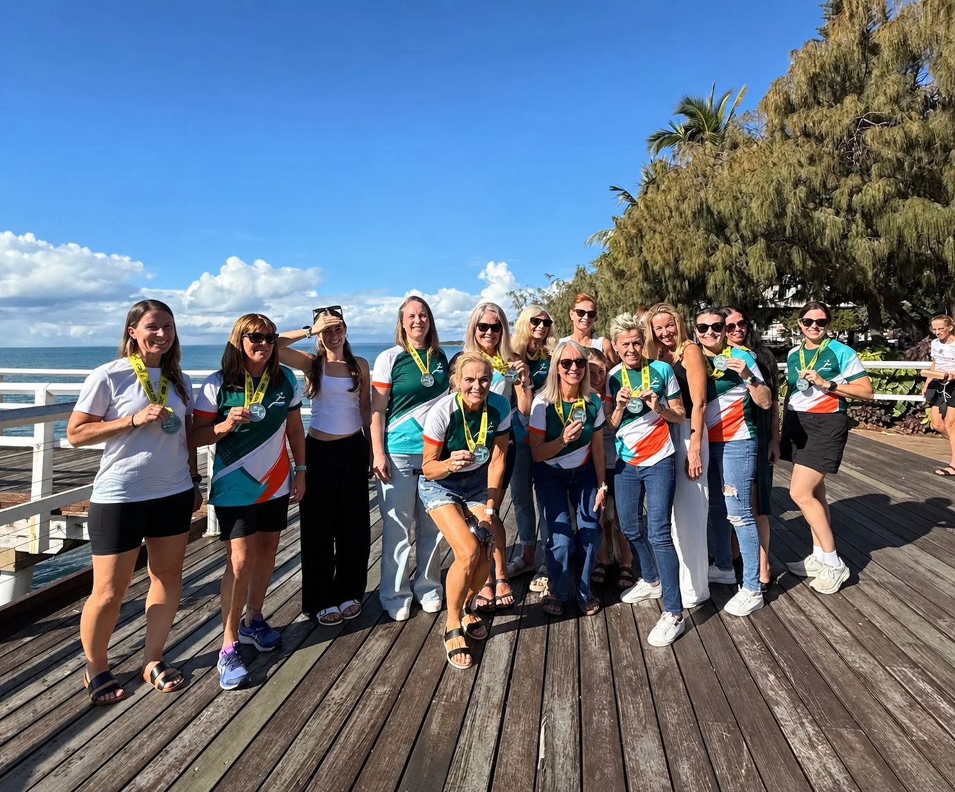 Running-club members celebrating together after a beach event