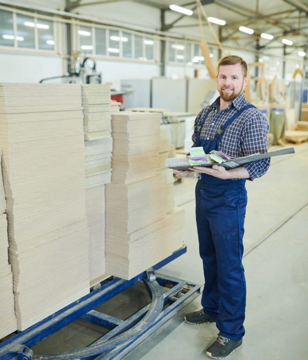 smiling-inspector-with-folder-working-at-factory-2021-09-24-03-51-46-utc